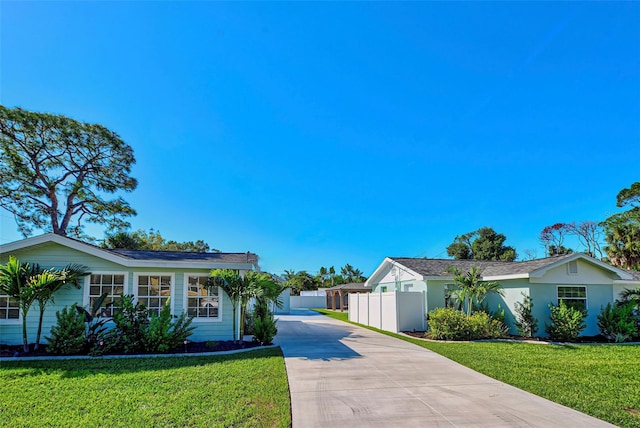 ranch-style home featuring a front yard