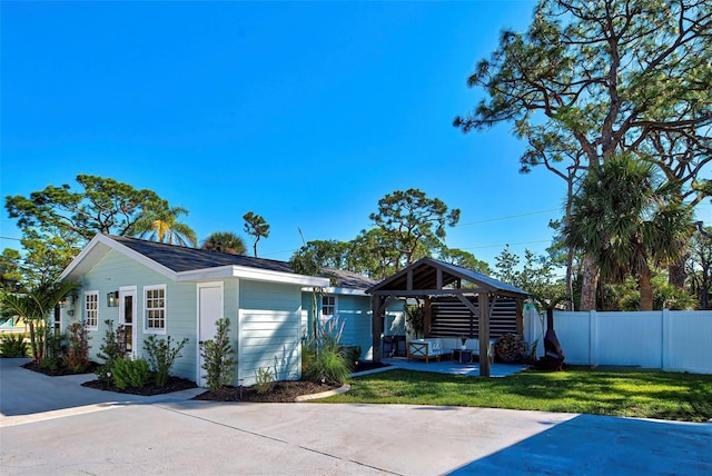 view of front of home featuring a gazebo, a front yard, and a patio