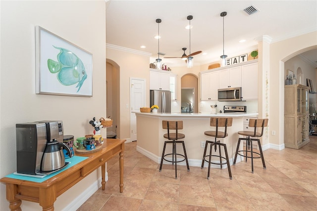 kitchen with appliances with stainless steel finishes, a kitchen island with sink, light tile floors, and pendant lighting