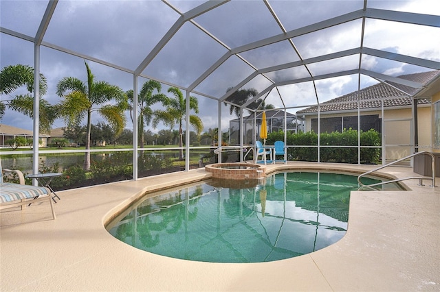 view of swimming pool featuring glass enclosure, a patio area, and an in ground hot tub