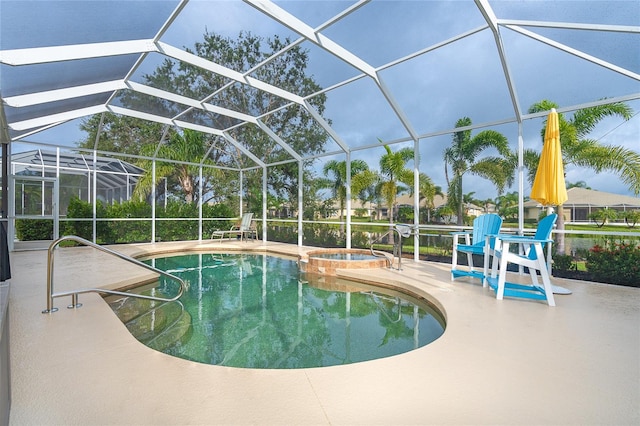 view of swimming pool with a lanai, a patio area, and an in ground hot tub