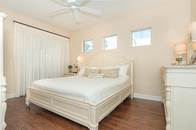 bedroom featuring ceiling fan, multiple windows, and dark hardwood / wood-style floors