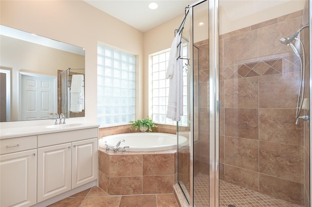 bathroom with independent shower and bath, large vanity, and tile flooring