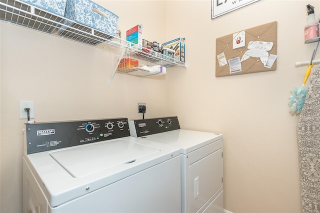 laundry room featuring electric dryer hookup and washing machine and dryer