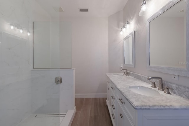 bathroom featuring hardwood / wood-style floors, vanity, and walk in shower