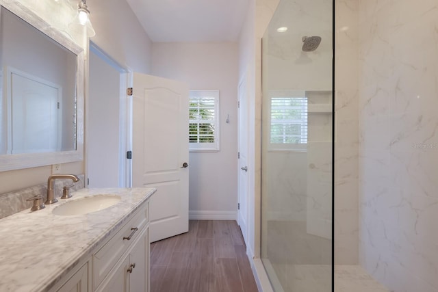 bathroom with vanity and a tile shower