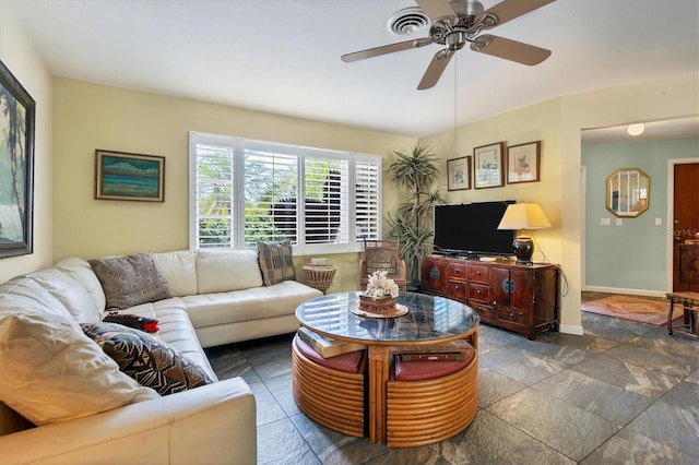 tiled living room with ceiling fan