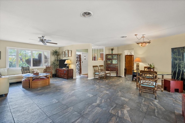 living room featuring dark tile floors and ceiling fan