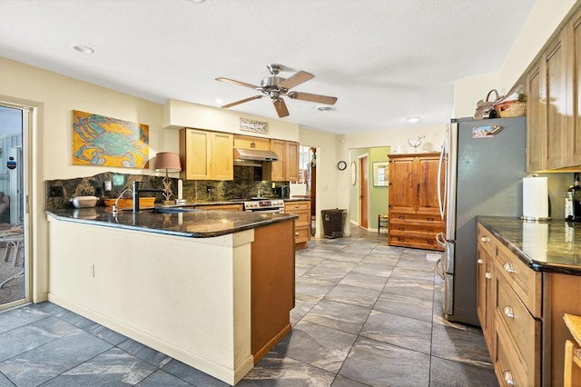 kitchen featuring ceiling fan, tile floors, kitchen peninsula, and tasteful backsplash