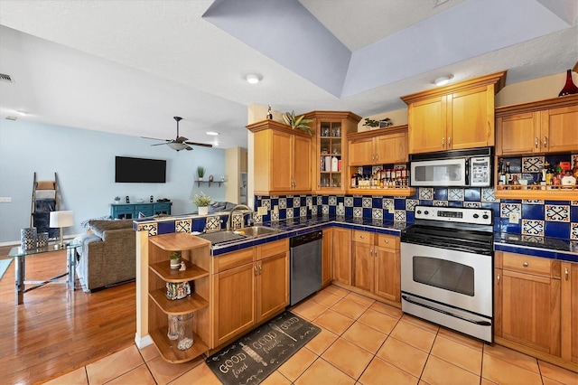 kitchen with visible vents, appliances with stainless steel finishes, open floor plan, open shelves, and a sink