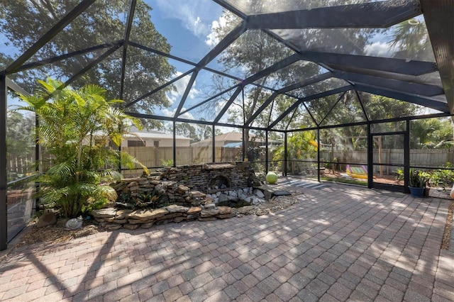 view of patio / terrace with a lanai and a fenced backyard