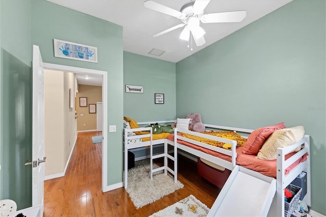 bedroom with baseboards, a ceiling fan, and wood finished floors