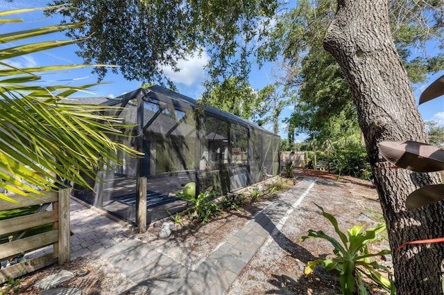 view of yard featuring glass enclosure