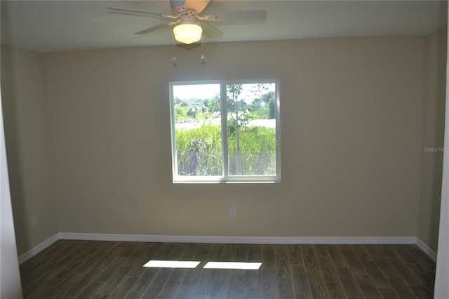 empty room featuring ceiling fan and dark wood-type flooring