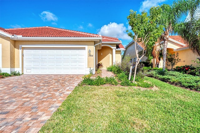 mediterranean / spanish-style home featuring a front yard and a garage