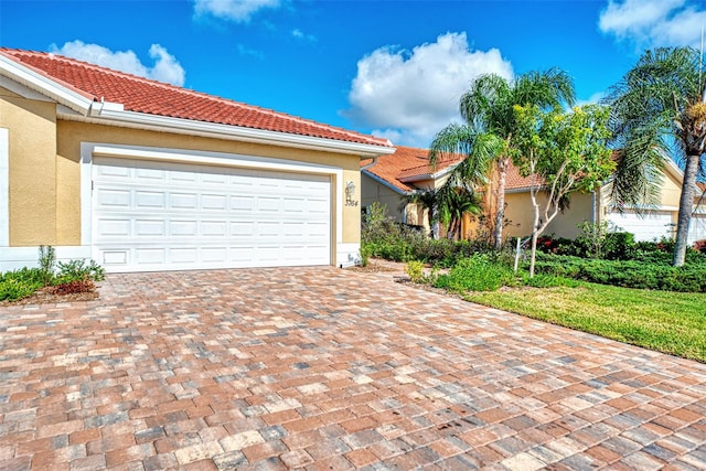 mediterranean / spanish-style home with a garage