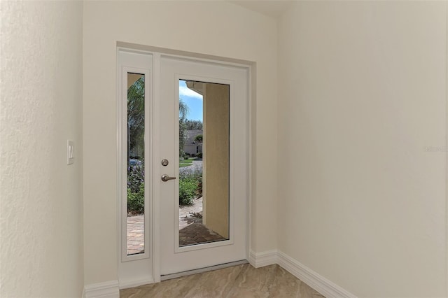 entryway with plenty of natural light and light tile floors