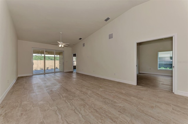 unfurnished living room featuring high vaulted ceiling, ceiling fan, and light tile floors