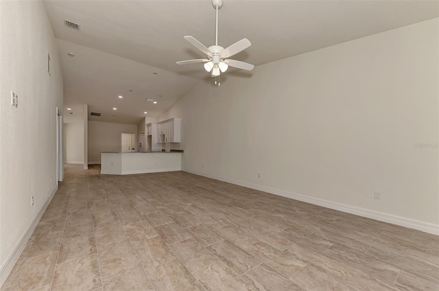 unfurnished living room featuring light tile floors, vaulted ceiling, and ceiling fan