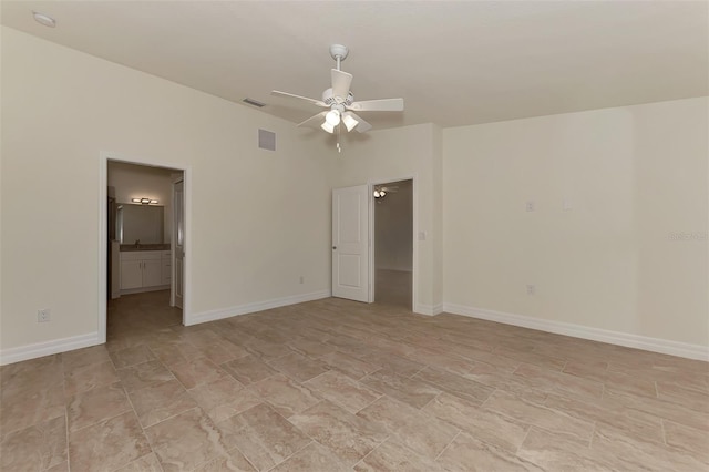 empty room with ceiling fan and light tile floors