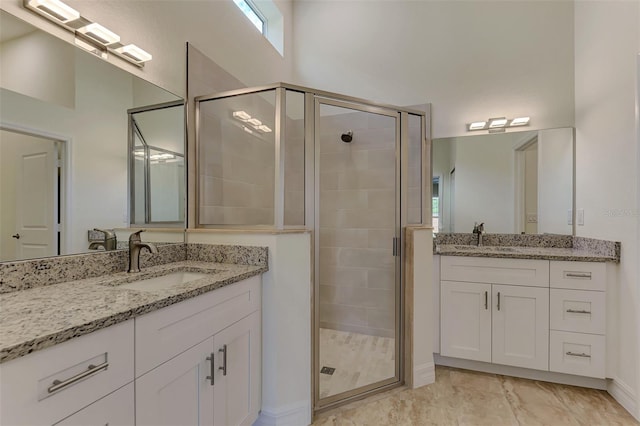 bathroom with tile flooring, walk in shower, and vanity