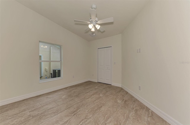 unfurnished room featuring lofted ceiling and ceiling fan