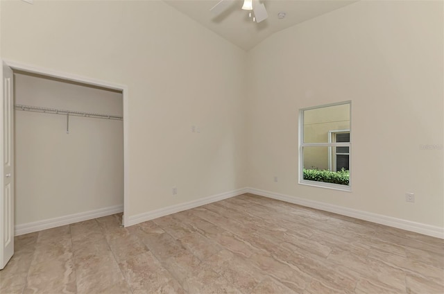 unfurnished bedroom with a closet, high vaulted ceiling, ceiling fan, and light tile floors