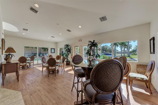 dining area featuring light hardwood / wood-style flooring, french doors, and a wealth of natural light