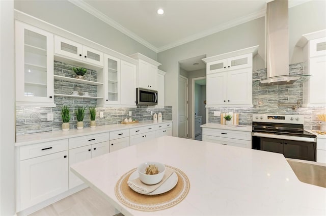 kitchen with backsplash, stainless steel appliances, wall chimney exhaust hood, and white cabinetry