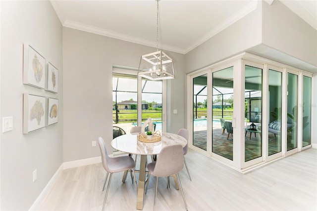 dining space featuring ornamental molding and light hardwood / wood-style flooring