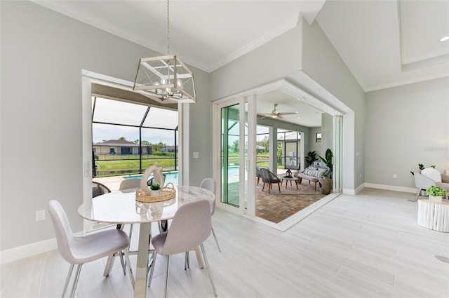 dining space featuring crown molding, ceiling fan with notable chandelier, and a healthy amount of sunlight