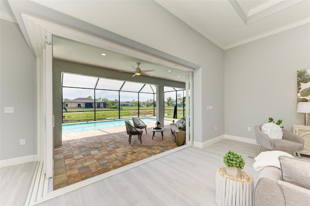 living room featuring light hardwood / wood-style flooring, ceiling fan, and crown molding