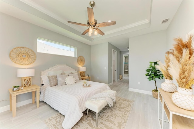 bedroom featuring a tray ceiling, ceiling fan, and crown molding