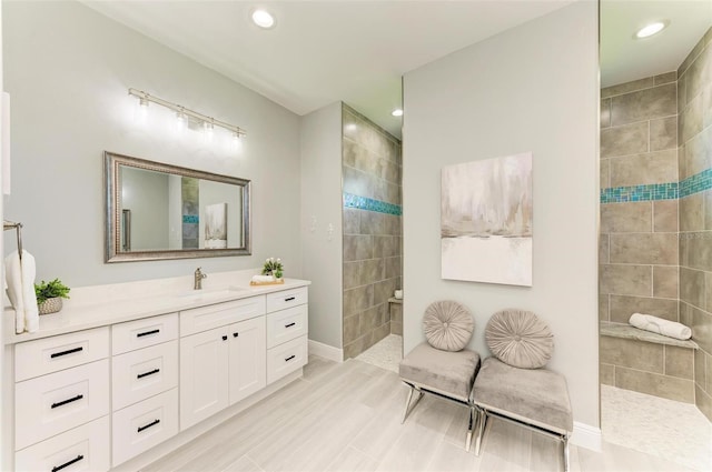 bathroom with tile floors, a tile shower, and oversized vanity