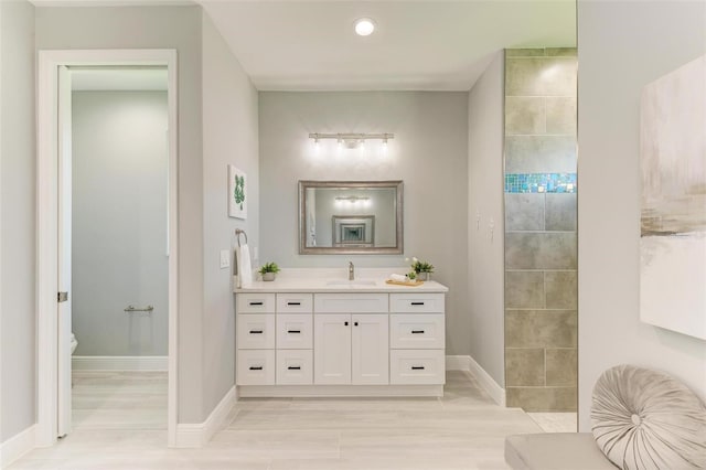 bathroom with toilet and large vanity