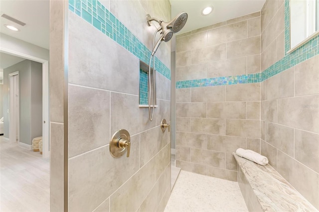 bathroom with tile walls and tiled shower