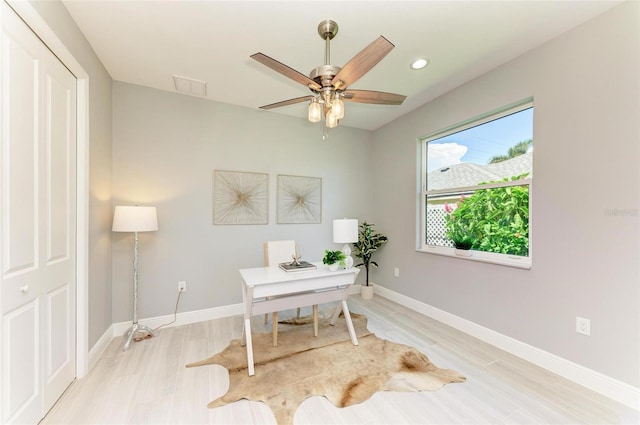 office space featuring light hardwood / wood-style floors and ceiling fan