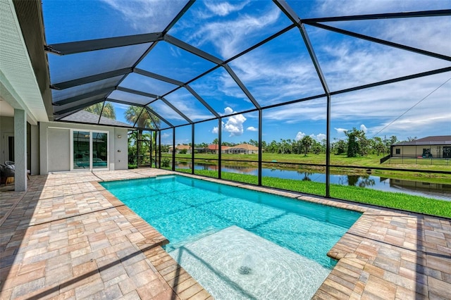 view of pool featuring a patio area, glass enclosure, and a water view