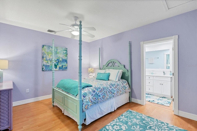 bedroom with ensuite bath, ceiling fan, hardwood / wood-style floors, and sink