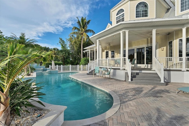 view of swimming pool featuring ceiling fan and a patio