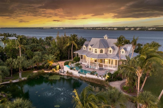 aerial view at dusk with a water view