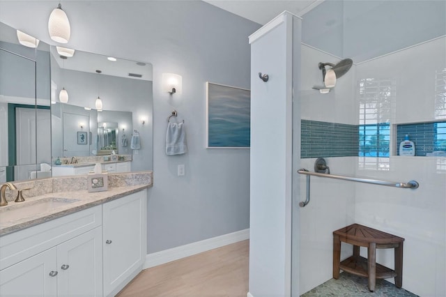 bathroom featuring vanity and a shower with shower door