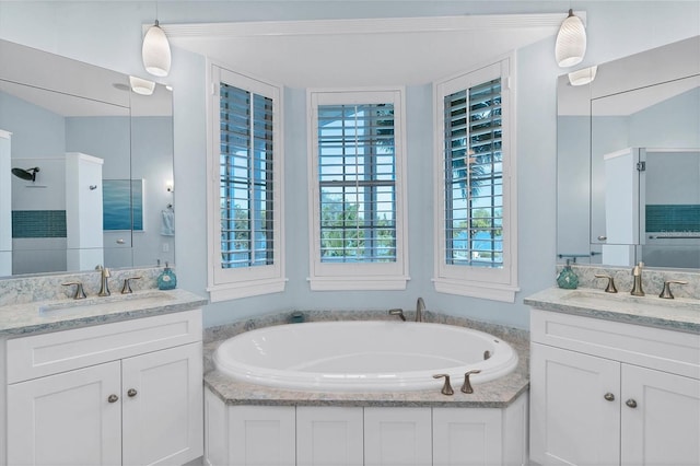 bathroom featuring a washtub and vanity