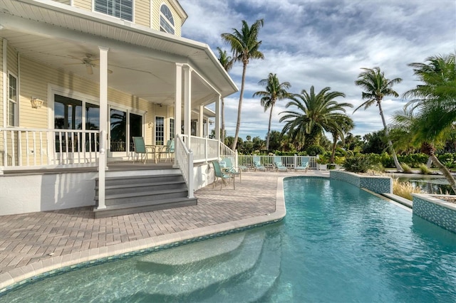 view of swimming pool featuring a patio and ceiling fan