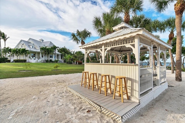 view of community featuring exterior bar and a lawn