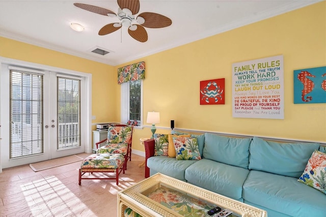 living room with ceiling fan, ornamental molding, and light tile patterned flooring