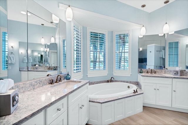 bathroom with a bathing tub and vanity