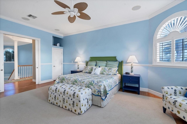 bedroom featuring ceiling fan, crown molding, and hardwood / wood-style floors