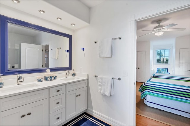 bathroom with vanity, hardwood / wood-style flooring, and ceiling fan