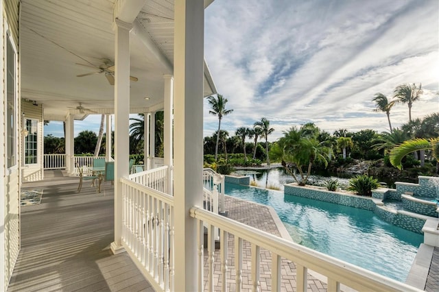 view of swimming pool featuring a water view and ceiling fan